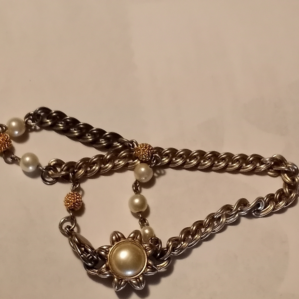 A double chained bracelet with reversible pendent